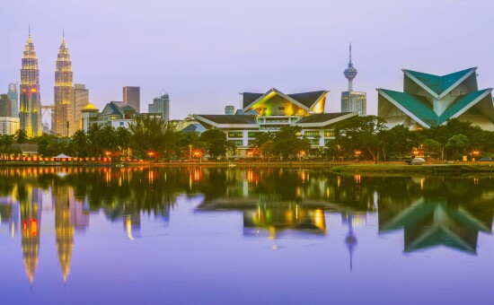 Skyline of Kuala Lumpur by the lake at dusk