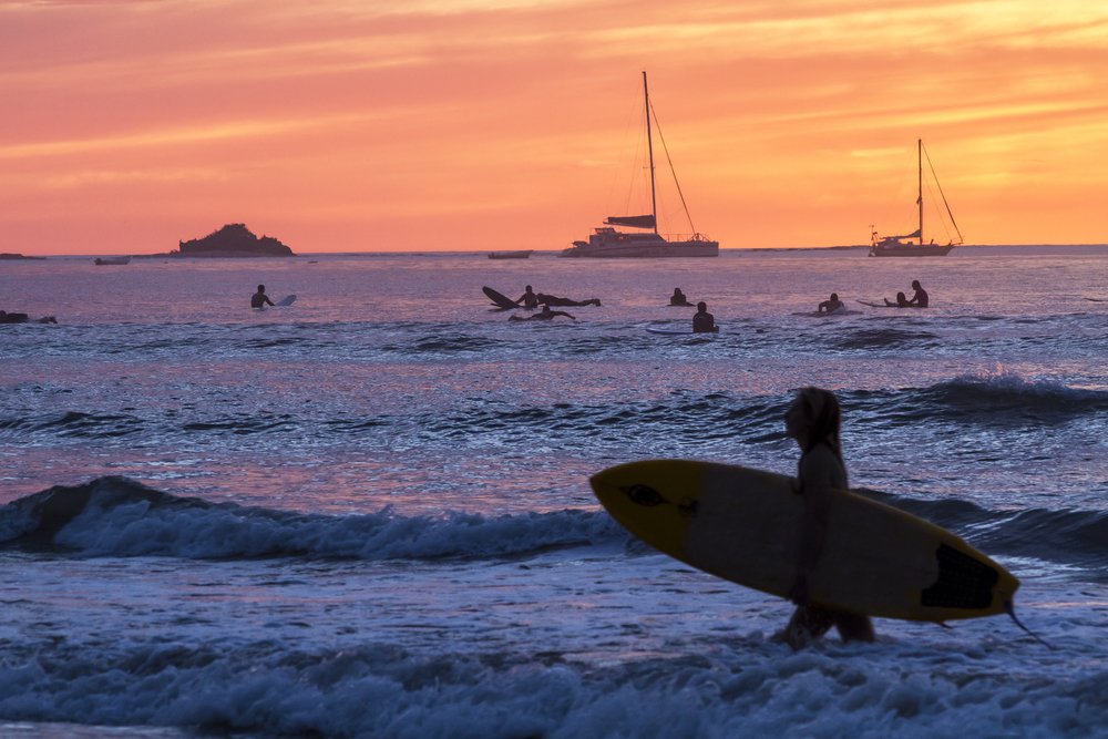 Surfers and sailboats in Costa Rica