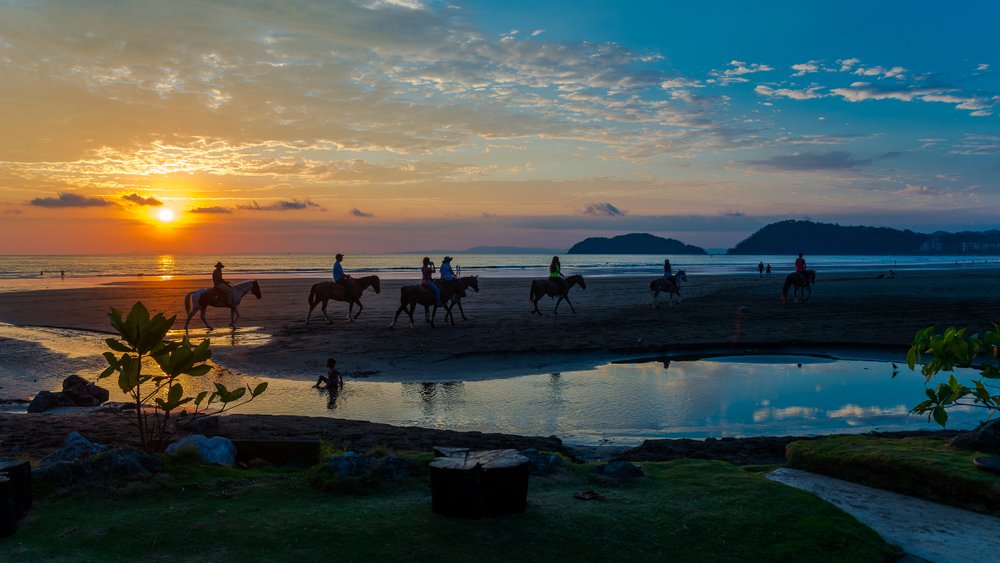 People horseback riding on the beaches in Jaco Costa Rica