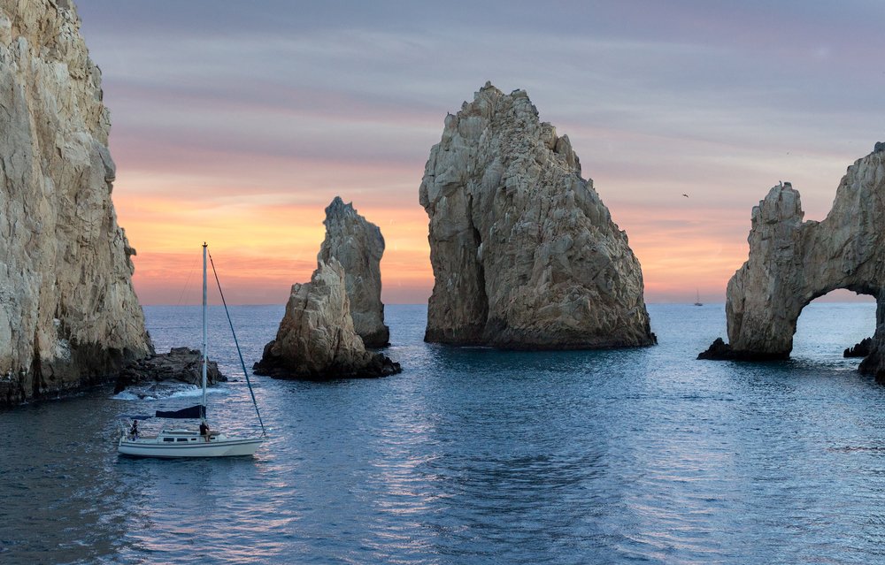 unique rock formations and sailboat in Cabo San Lucas, Mexico