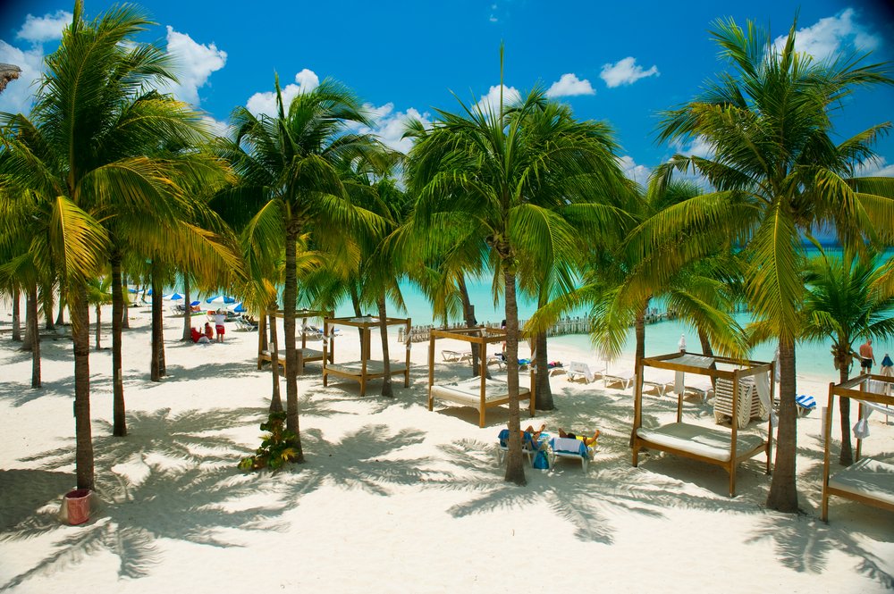 lounge beds in the shade on the beach in Isla Mujeres, Mexico