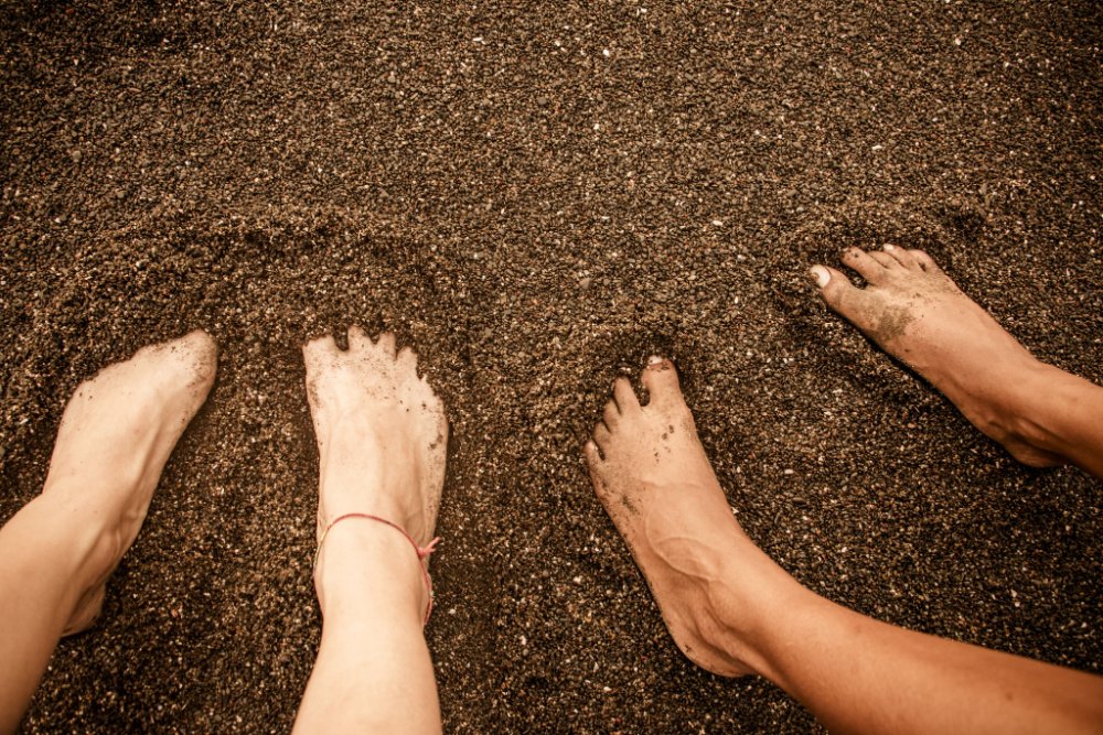 feet in black sand