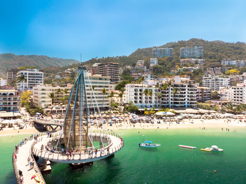 view of Puerto Vallarta beach town pier and shore from water