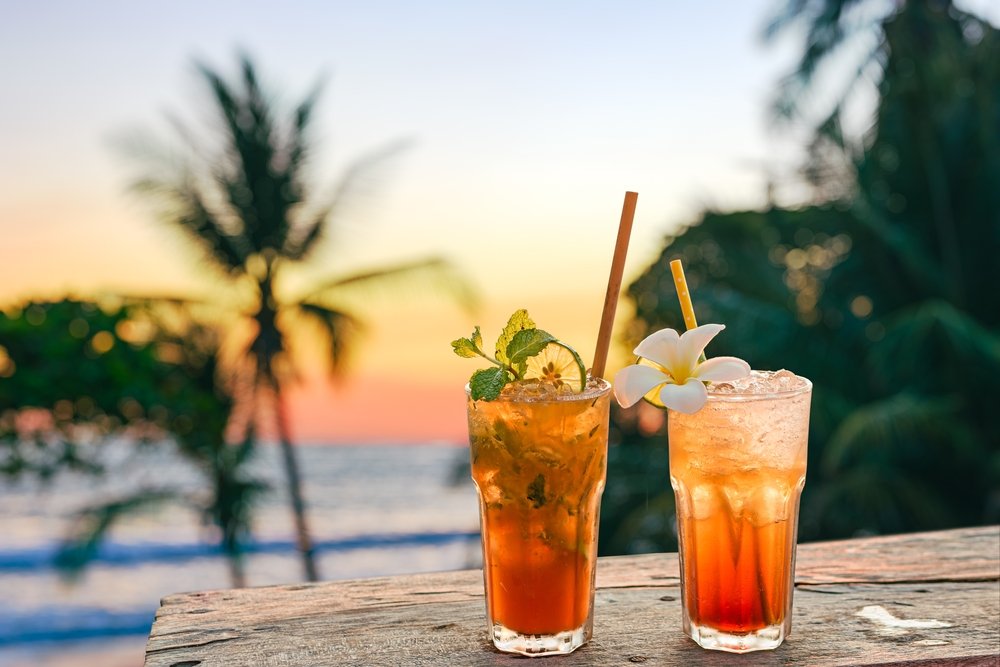 two drinks near the beach at sunset