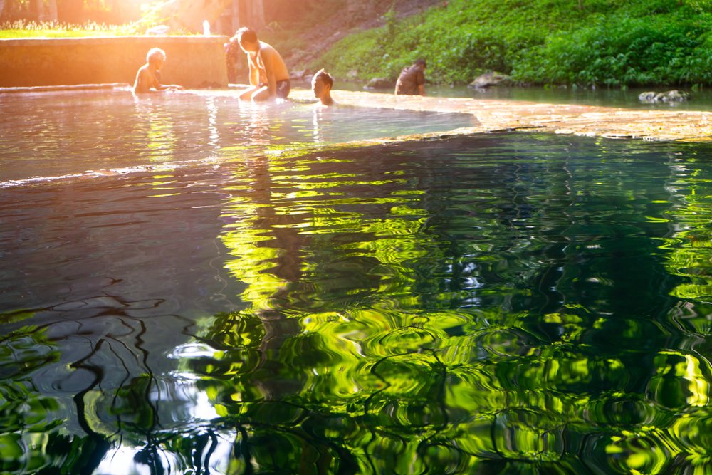 people soaking in Hin Dat Hot Springs, Kanchanaburi Thailand