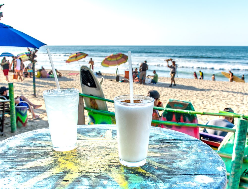 2 margaritas on a table on the beach in Mexico