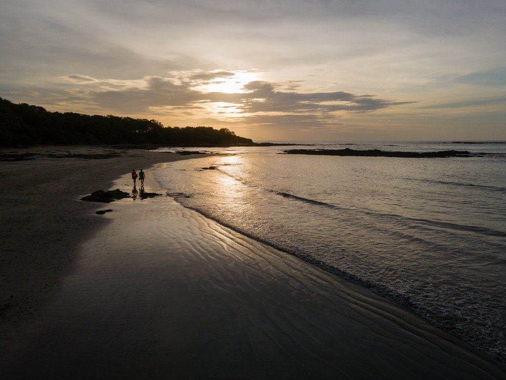 couple walking on Tamarindo Beach Costa Rica