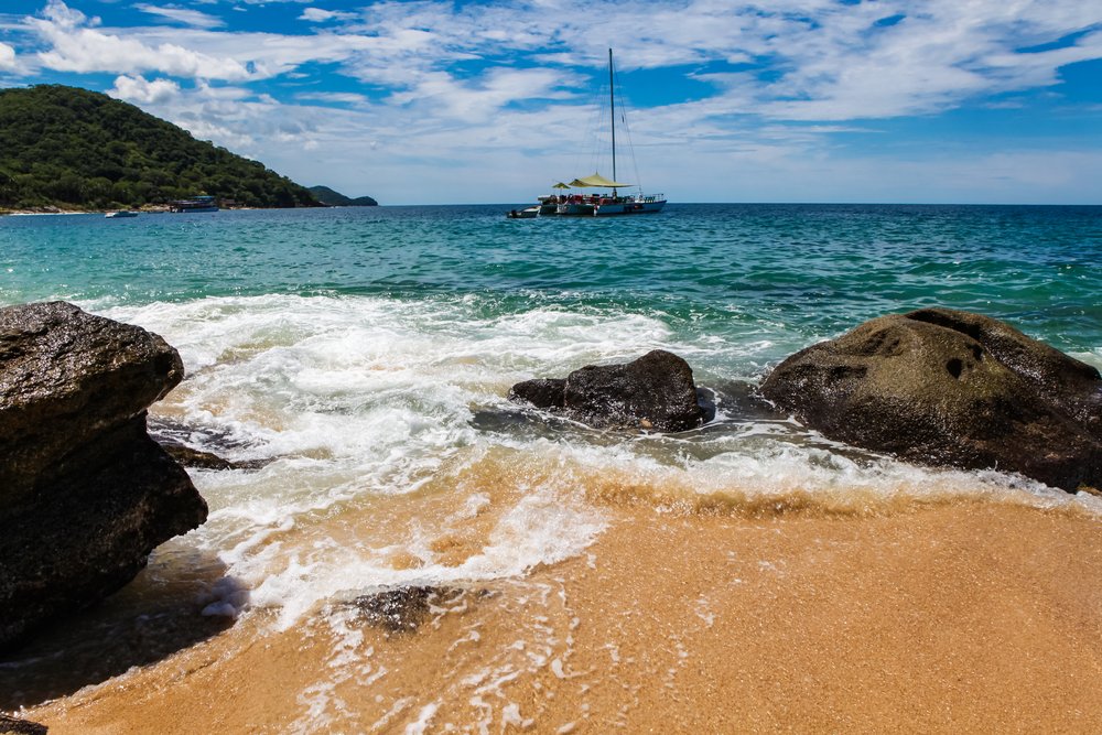 Sailboat in the distance at Playa Quimixto