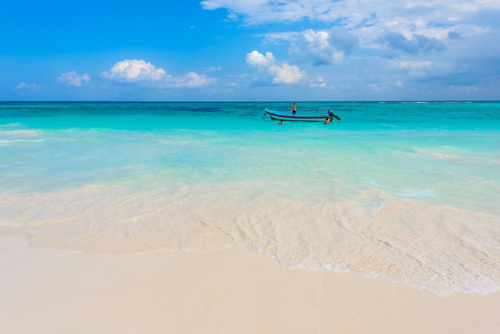 clear turquoise water with a boat in it