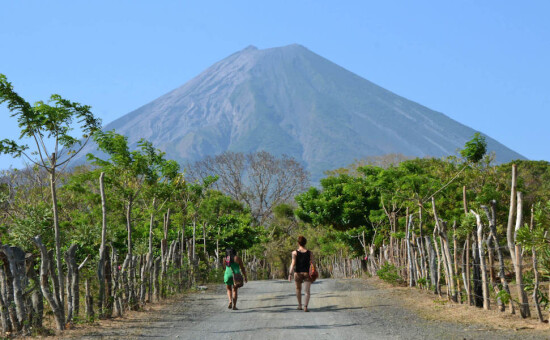 2 people walking towrd volcano in Nicaragua