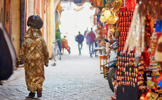 woman with bag balanced on head in Morocco