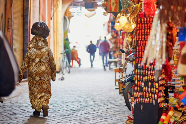 woman with bag balanced on head in Morocco